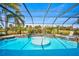 Relaxing pool and spa with a screened enclosure and a view at 2123 Calusa Lakes Blvd, Nokomis, FL 34275