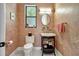Charming bathroom with patterned wallpaper and pedestal sink at 2139 Hawthorne St, Sarasota, FL 34239