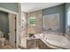 Main bathroom with walk-in shower, soaking tub, and tiled floors at 2139 Hawthorne St, Sarasota, FL 34239