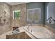 Spa-like bathroom with soaking tub, walk-in shower, and tiled walls at 2139 Hawthorne St, Sarasota, FL 34239