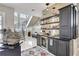 Modern home bar with dark cabinetry, shelving, and a wine refrigerator at 2139 Hawthorne St, Sarasota, FL 34239