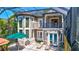 Two-story house with a balcony, screened-in pool, and patio at 2139 Hawthorne St, Sarasota, FL 34239