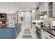 Bright kitchen with an island, white cabinets, and a blue accent at 2139 Hawthorne St, Sarasota, FL 34239