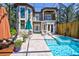 Inviting pool area with spa, covered patio, and lush landscaping at 2139 Hawthorne St, Sarasota, FL 34239