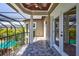 Spacious screened balcony with tiled floor and French doors at 2139 Hawthorne St, Sarasota, FL 34239