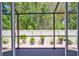Relaxing screened patio with wood deck and lush landscaping at 2139 Hawthorne St, Sarasota, FL 34239