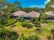 Aerial view of a home with a spacious backyard, lush landscaping, and screened patio at 293 Turquoise Ln, Osprey, FL 34229