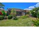 Landscaped backyard with a large screened patio and lush greenery at 293 Turquoise Ln, Osprey, FL 34229