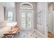 Bright entryway with double doors, wood-look floors, and neutral wall decor at 293 Turquoise Ln, Osprey, FL 34229