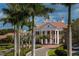 Impressive two-story clubhouse entrance with columns and palm trees at 293 Turquoise Ln, Osprey, FL 34229
