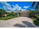 Front view of a single-story home with a brick driveway and landscaped yard at 293 Turquoise Ln, Osprey, FL 34229