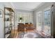 Home office with built-in shelves, hardwood floors, and French doors at 293 Turquoise Ln, Osprey, FL 34229