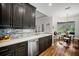 Bright kitchen features dark cabinetry, stainless steel appliances, and a breakfast nook at 293 Turquoise Ln, Osprey, FL 34229