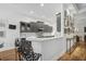 Modern kitchen with dark gray cabinetry, white countertops, and breakfast bar at 293 Turquoise Ln, Osprey, FL 34229