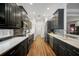 Modern kitchen features dark cabinetry, stainless steel appliances, and quartz countertops at 293 Turquoise Ln, Osprey, FL 34229