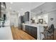 Modern kitchen with dark gray cabinetry, stainless steel appliances, and breakfast bar at 293 Turquoise Ln, Osprey, FL 34229