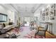 Spacious living room with hardwood floors, comfy seating, and large windows at 293 Turquoise Ln, Osprey, FL 34229