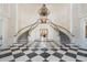 Elegant lobby with double staircase, chandelier, and checkered floor at 293 Turquoise Ln, Osprey, FL 34229