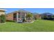 Large backyard with grassy area and screened patio at 322 Siena Vista Pl, Sun City Center, FL 33573