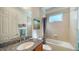 Small bathroom with tub and granite countertop at 322 Siena Vista Pl, Sun City Center, FL 33573