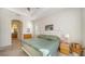 Bright bedroom with a king-size bed and ensuite bathroom access at 322 Siena Vista Pl, Sun City Center, FL 33573
