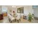 Dining room features glass table, white chairs, and large art at 322 Siena Vista Pl, Sun City Center, FL 33573