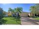 Single-Gathering home with a two-car garage and lush landscaping at 322 Siena Vista Pl, Sun City Center, FL 33573