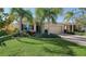 Well-maintained house with palm trees and a brick driveway at 322 Siena Vista Pl, Sun City Center, FL 33573