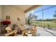Screened lanai with outdoor seating and golf course view at 322 Siena Vista Pl, Sun City Center, FL 33573