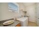 Laundry room with washer, dryer, and built-in shelving at 322 Siena Vista Pl, Sun City Center, FL 33573