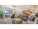 Open concept living room with gray sectional sofa and patio access at 322 Siena Vista Pl, Sun City Center, FL 33573
