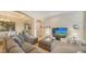 Spacious living room with sectional sofa and large flat-screen TV at 322 Siena Vista Pl, Sun City Center, FL 33573