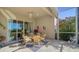 Relaxing screened patio with wicker furniture and lush landscaping at 322 Siena Vista Pl, Sun City Center, FL 33573