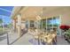 Covered patio with seating area, ceiling fan, and glass sliding doors at 322 Siena Vista Pl, Sun City Center, FL 33573