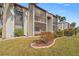 Condo building with screened-in patio and landscaping at 3267 Beneva Rd # 201, Sarasota, FL 34232