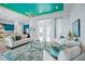 Open concept living room with teal and white color scheme at 4779 Pastel Ct, Sarasota, FL 34240