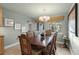 Formal dining room with rich wood table and elegant light fixture at 4817 Ocean Blvd, Sarasota, FL 34242