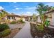 Landscaped front yard with tropical plants and walkway at 4817 Ocean Blvd, Sarasota, FL 34242