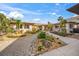 Landscaped front yard with stone pathways and tropical plants at 4817 Ocean Blvd, Sarasota, FL 34242