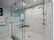 Large walk-in shower with marble tile and glass enclosure at 4817 Ocean Blvd, Sarasota, FL 34242