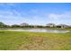 Landscaped backyard with pond view and community backdrop at 5107 Coral Reef Way, Bradenton, FL 34211