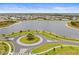 Aerial view of a tranquil lake and circular road within a residential community at 5107 Coral Reef Way, Bradenton, FL 34211
