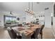 Open concept dining room with kitchen and living room views, large table, and chandelier at 5107 Coral Reef Way, Bradenton, FL 34211