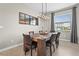 Elegant dining room features a large wooden table with leather chairs and a modern chandelier at 5107 Coral Reef Way, Bradenton, FL 34211
