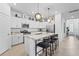 Modern kitchen with white cabinets, granite counters, and island with seating at 5107 Coral Reef Way, Bradenton, FL 34211