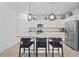 Modern kitchen with white cabinets, granite counters, and island with seating at 5107 Coral Reef Way, Bradenton, FL 34211