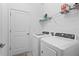Bright laundry room with washer, dryer, and ample shelving at 5107 Coral Reef Way, Bradenton, FL 34211