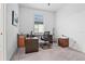 Bright home office with a large desk, chair, and printer at 5107 Coral Reef Way, Bradenton, FL 34211