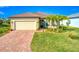 Single-story home with tile roof and paver driveway at 7675 Summerland Cv, Bradenton, FL 34202