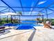 Enclosed pool and spa with water view at 7675 Summerland Cv, Bradenton, FL 34202